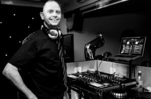 a man standing in front of a dj equipment